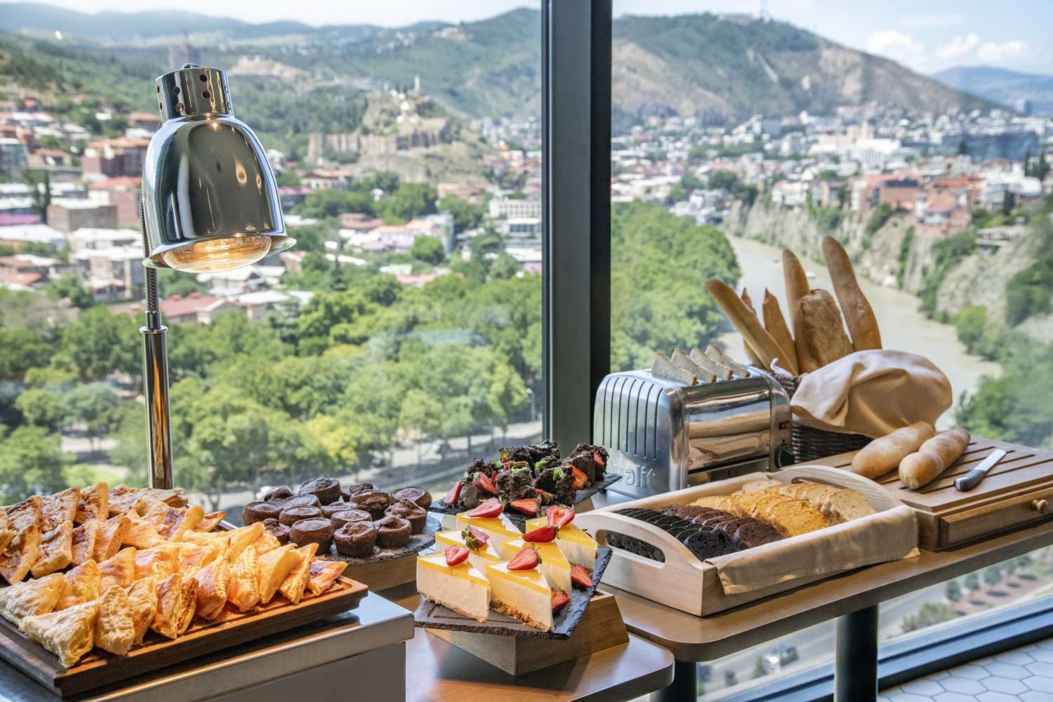 Pastries and bread selection with Tbilisi city views at TITA Restaurant